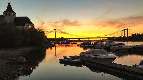 Bridge over river against sky during sunset