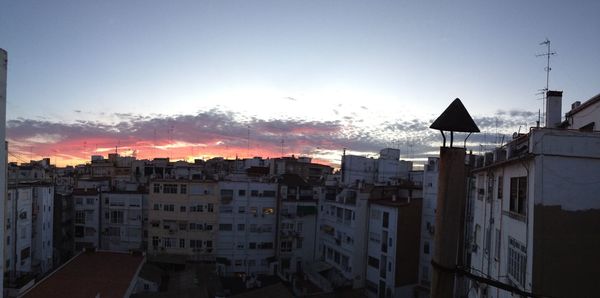 Buildings in city at sunset