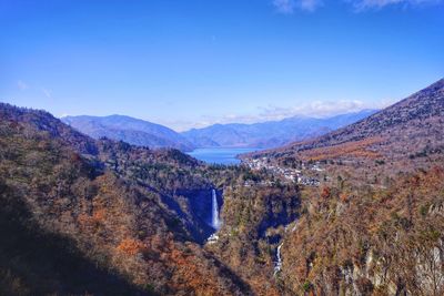 Scenic view of mountains against blue sky