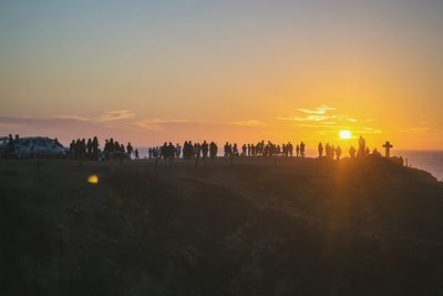 Silhouette people on city during sunset