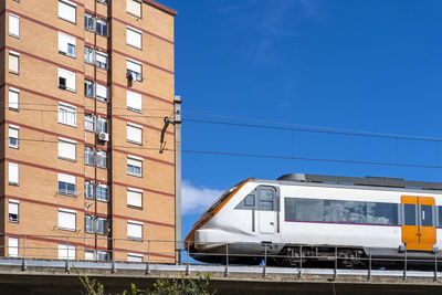 Commuter train on an elevated bridge in an apartment area in the city of hospitalet de llobregat 