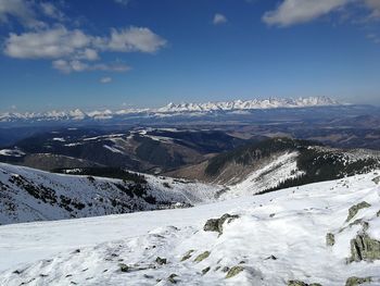 Scenic view of snowcapped mountains against sky