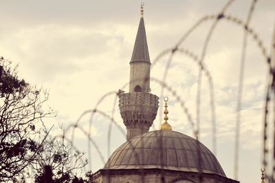 Low angle view of historic mosque against sky