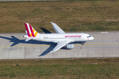 Side view of airplane on airport runway