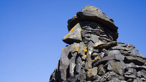 Low angle view of statue against blue sky