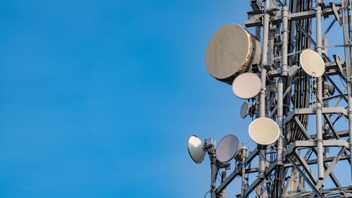 Telecommunications tower with satellite dishes and receivers