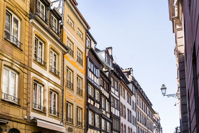 Low angle view of buildings against clear sky in city