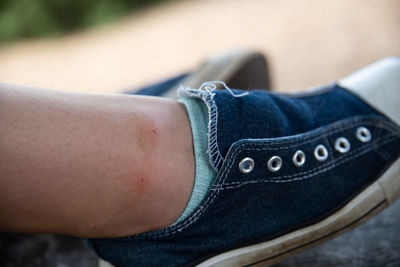 Low section of man wearing shoes