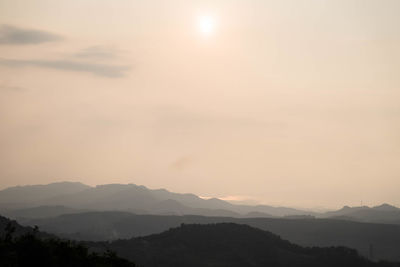 Scenic view of silhouette mountains against sky during sunset