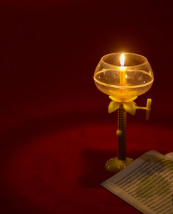 Close-up of illuminated lamp on table