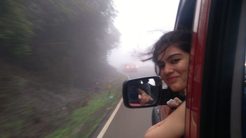 Close-up of young woman in car