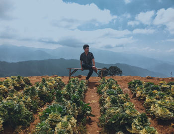 Man standing by mountain against sky