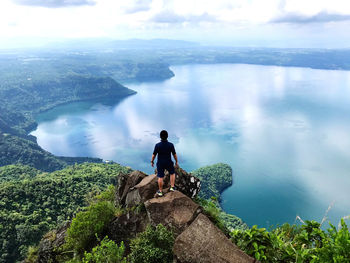 People looking at view of mountains against sky