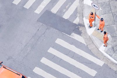 High angle view of people walking on road