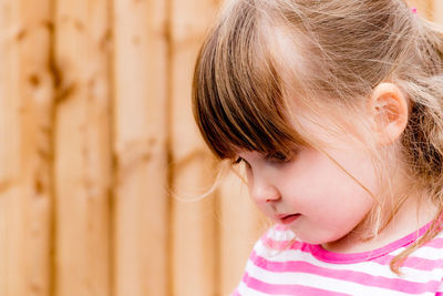 Close-up of cute girl looking down outdoors