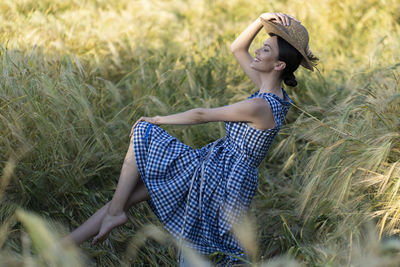 Side view of woman standing on field