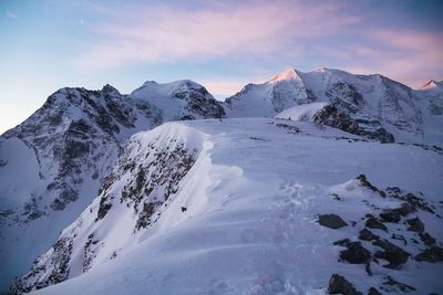 Scenic view of snow covered mountains against sky