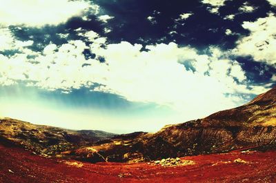 Scenic view of landscape against cloudy sky