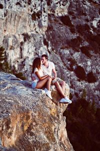 Young woman kissing on cliff