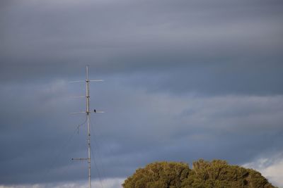 Low angle view of electricity pylon against sky