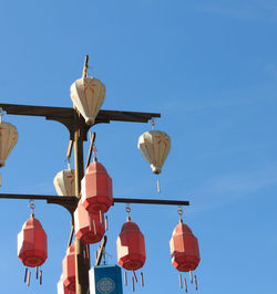 Low angle view of lanterns hanging against clear sky