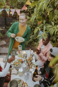 High angle view of leaves with friends partying in back yard