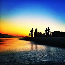 Silhouette of people at sunset