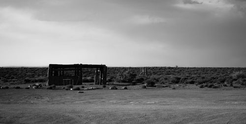 Abandoned built structure on field against sky