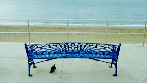 Close-up of deck chairs on beach