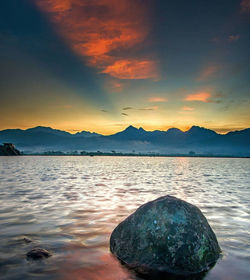 Scenic view of lake against sky during sunset