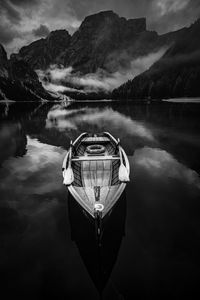 Digital composite image of braies lake and mountains against sky