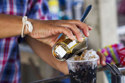 Midsection of man holding ice cream