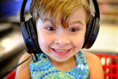 Close-up of girl listening music with headphones