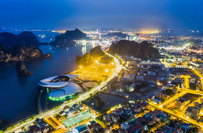 High angle view of illuminated cityscape against sky at night