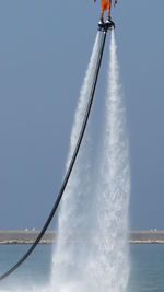 Person flyboarding in sea