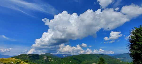 Low angle view of clouds over mountain