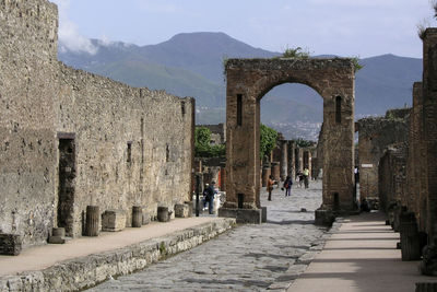 People at historic built structure against sky