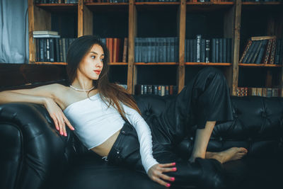 Portrait of young woman sitting in gym