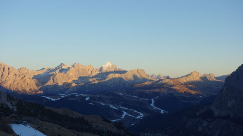 Scenic view of mountains against clear sky during winter