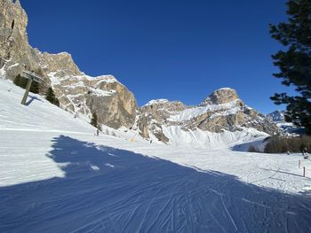 Scenic view of snowcapped mountains against clear blue sky