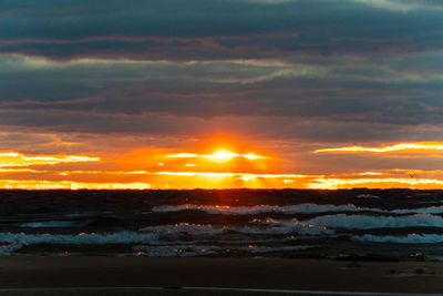 Scenic view of dramatic sky over sea during sunset