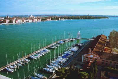 High angle view of buildings by sea against sky