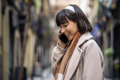 Portrait of smiling young woman standing outdoors