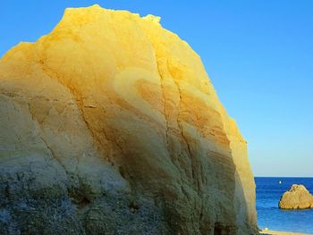 Scenic view of rock formation against clear blue sky