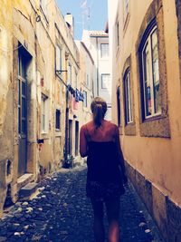 Rear view of man in front of building