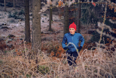 High angle view of woman hiking in forest
