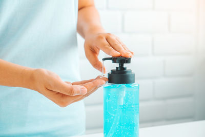 Close-up of woman hand holding bottle