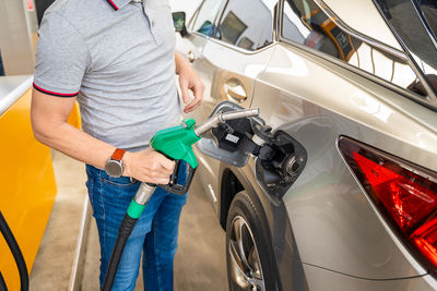 Low section of man washing car