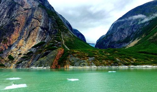 Scenic view of lake and mountains against sky