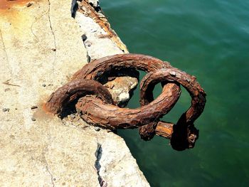 High angle view of rusty chain on lake